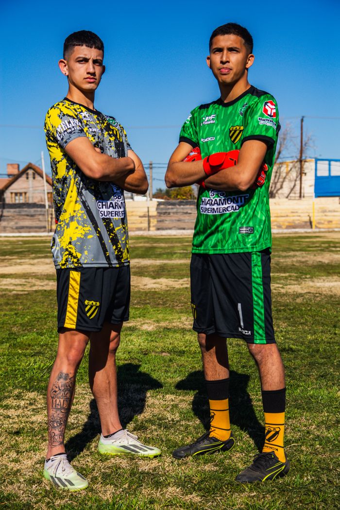 The Art of Drawing Readers In: Your attractive post title goes here Two young men in football uniforms posing confidently on a grassy field under a clear blue sky.